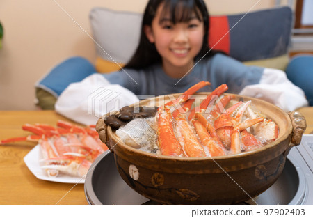Teenage women eating crab hot pot Teenage women eating crab hot pot 97902403