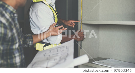 Professional architect designer structural engineer team colleagues discussing building plan design project 97903345