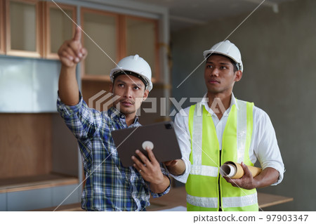 Professional architect designer structural engineer team colleagues discussing building plan design project 97903347