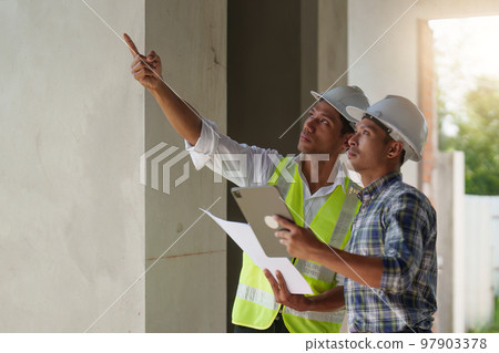 Professional architect designer structural engineer team colleagues discussing building plan design project 97903378