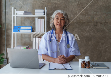 Doctor having conversation with patient while discussing explaining symptom and hold hand for encourage 97903465