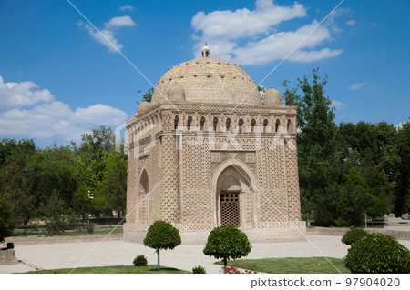 Samanid stone mausoleum in a park in Bukhara, Uzbekistan. Tourism, travel concept. 97904020