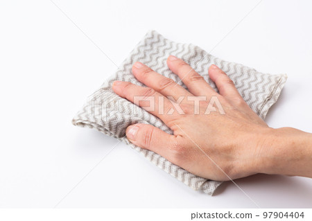 A woman's hand wiping with a kitchen cloth (disposable dishcloth) A woman's hand wiping with a kitchen cloth (disposable dishcloth) 97904404