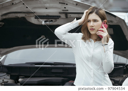 Young woman calling emergency help near broken car on road. Young woman calling emergency help near broken car on road. 97904534