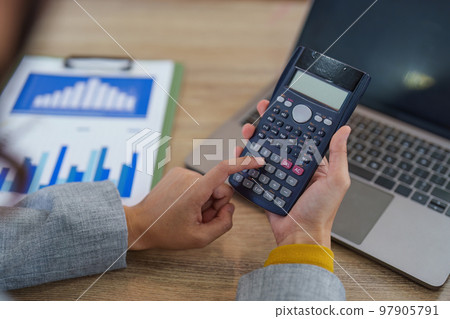 Financial analyst analyzes business people investment consultant analyzing company financial report working with documents graphs. Stock Market Tax Fund Finance concept. 97905791