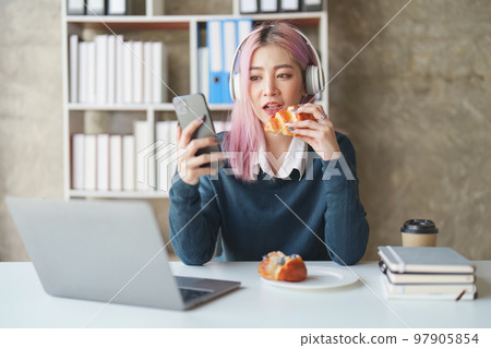 Young woman feeling excited at gaming on mobile phone, A gamer people playing video game online with smart mobile phone Young woman feeling excited at gaming on mobile phone, A gamer people playing video game online with smart mobile phone 97905854