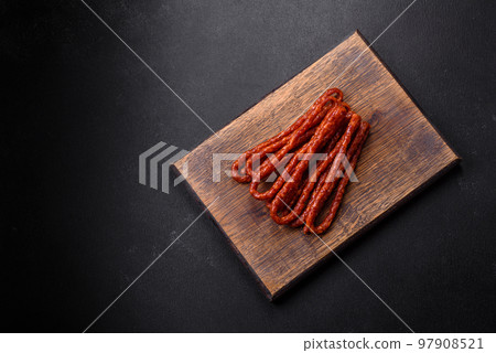 Delicious thin smoked meat sausages with spices and herbs 97908521