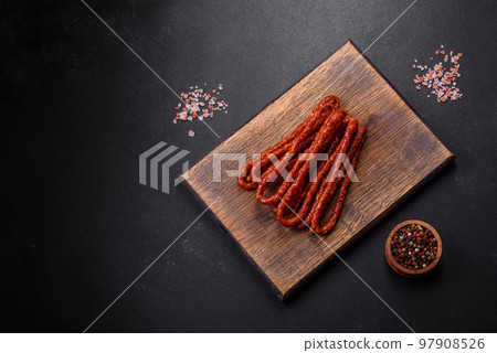 Delicious thin smoked meat sausages with spices and herbs 97908526