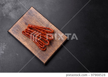 Delicious thin smoked meat sausages with spices and herbs Delicious thin smoked meat sausages with spices and herbs 97908528