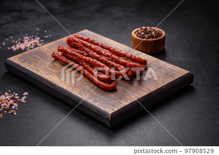 Delicious thin smoked meat sausages with spices and herbs 97908529