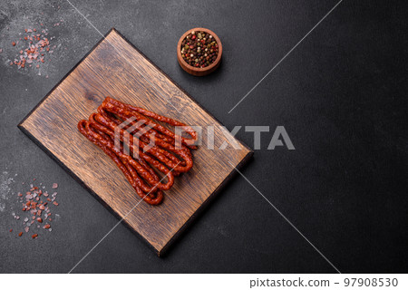 Delicious thin smoked meat sausages with spices and herbs Delicious thin smoked meat sausages with spices and herbs 97908530
