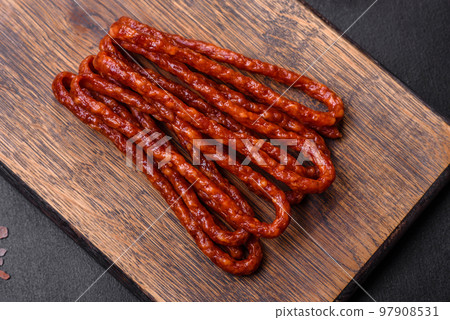 Delicious thin smoked meat sausages with spices and herbs Delicious thin smoked meat sausages with spices and herbs 97908531
