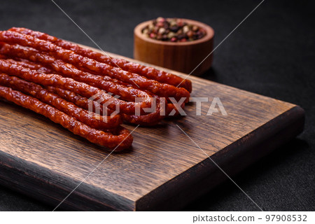 Delicious thin smoked meat sausages with spices and herbs 97908532