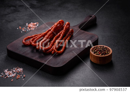 Delicious thin smoked meat sausages with spices and herbs 97908537