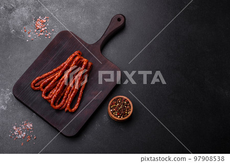 Delicious thin smoked meat sausages with spices and herbs 97908538