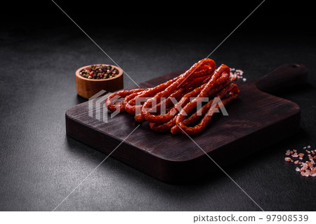 Delicious thin smoked meat sausages with spices and herbs 97908539