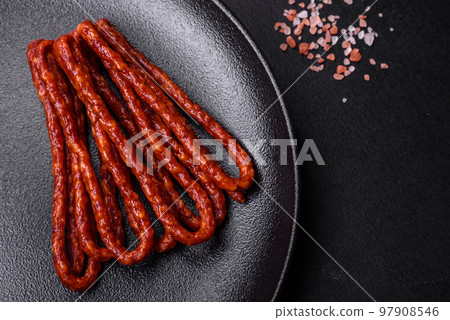 Delicious thin smoked meat sausages with spices and herbs 97908546