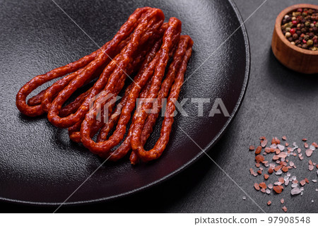 Delicious thin smoked meat sausages with spices and herbs 97908548