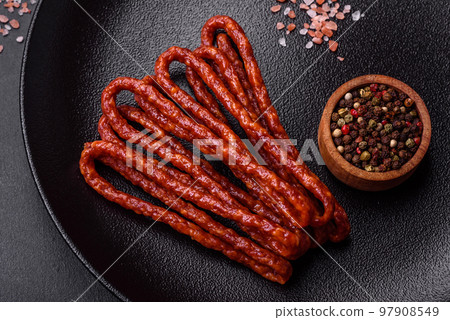 Delicious thin smoked meat sausages with spices and herbs 97908549