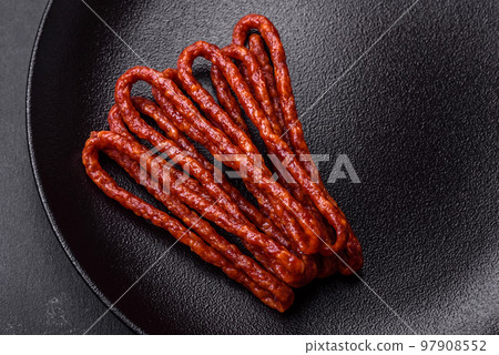 Delicious thin smoked meat sausages with spices and herbs 97908552