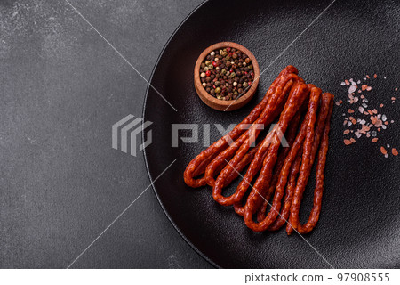 Delicious thin smoked meat sausages with spices and herbs Delicious thin smoked meat sausages with spices and herbs 97908555