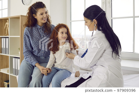 Caring doctor examine small girl in hospital Caring doctor examine small girl in hospital 97909396