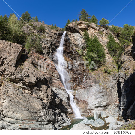 Lillaz waterfall (Cascate di Lillaz) sprays down granite rapids to pond. Cogne, Aosta valley, Italy 97910762
