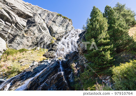 Multi-level alpine Lillaz waterfall (Cascate di Lillaz) washes granite karst rapids of rock 97910764