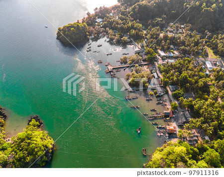 Aerial view of Bo Chet Luk port Harbour with long tail boats, in Satun Geopark, Thailand Aerial view of Bo Chet Luk port Harbour with long tail boats, in Satun Geopark, Thailand 97911316