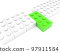 A row of white toy bricks with a green brick in the middle 97911584