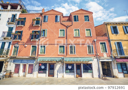 Worn building withj a small shop Worn building withj a small shop 97912691