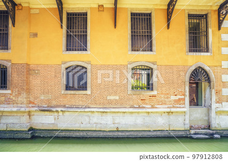 facade with windows covered with bars 97912808
