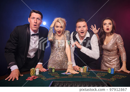 Group of a stylish rich friends are playing poker at casino. Group of a stylish rich friends are playing poker at casino. 97912867