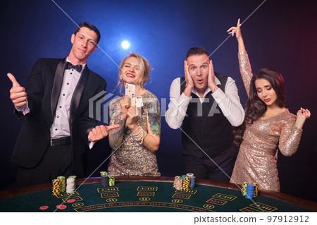 Group of a stylish rich friends are playing poker at casino. Group of a stylish rich friends are playing poker at casino. 97912912