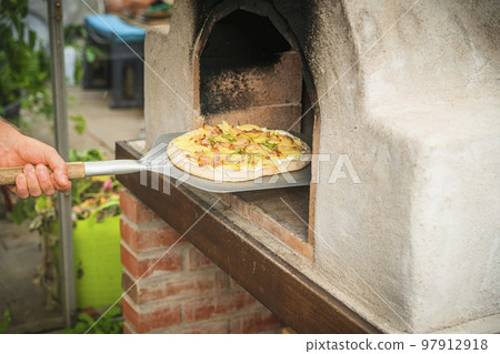 Homemade pizza on a shovel Homemade pizza on a shovel 97912918