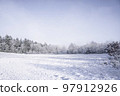 Snow covered field on a bright winter day Snow covered field on a bright winter day 97912926