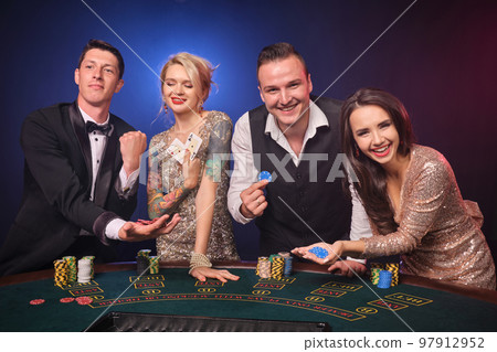Group of a stylish rich friends are playing poker at casino. Group of a stylish rich friends are playing poker at casino. 97912952