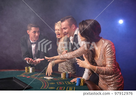 Group of a stylish rich friends are playing poker at casino. Group of a stylish rich friends are playing poker at casino. 97912976