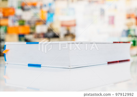 Close book lying on white table with soft blurred background 97912992