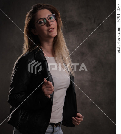 Photo shooting with a young attractive woman in a studio Photo shooting with a young attractive woman in a studio 97913380