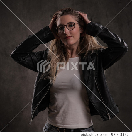 Attractive young woman poses for the camera Attractive young woman poses for the camera 97913382