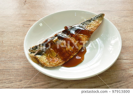 grilled saba fish or mackerel on plate dressing black sweet soybean sauce 97913800
