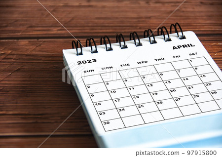 April 2023 white desk calendar on wooden table background. Calendar concept and copy space April 2023 white desk calendar on wooden table background. Calendar concept and copy space 97915800