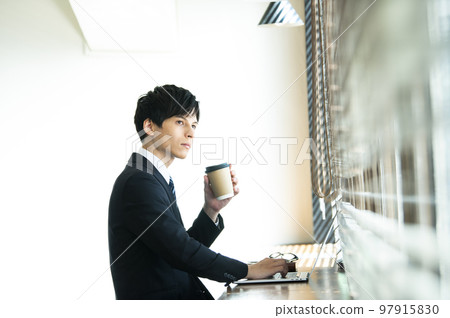 Young businessman working in a cafe Young businessman working in a cafe 97915830