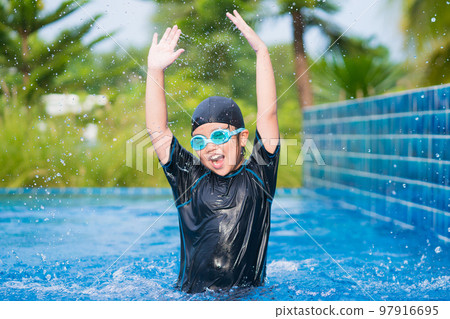 happy children Smiling cute little girl in sunglasses in swimming pool 97916695