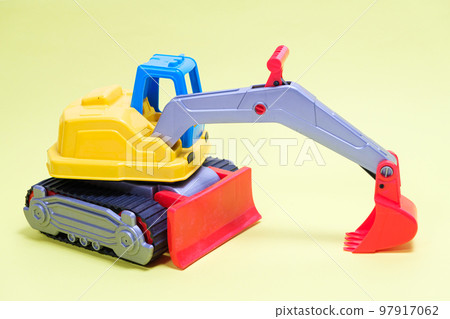 Plastic excavator car on yellow background. Construction machinery car for digging for toy store and children. 97917062