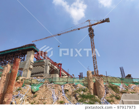 MELAKA, MALAYSIA -JUNE 19, 2022: A view of a construction site in full swing. Machines and workers are busy doing work. The safety level is ensured to reach the required standards. 97917973