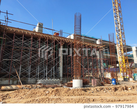MELAKA, MALAYSIA -JUNE 19, 2022: A view of a construction site in full swing. Machines and workers are busy doing work. The safety level is ensured to reach the required standards. MELAKA, MALAYSIA -JUNE 19, 2022: A view of a construction site in full swing. Machines and workers are busy doing work. The safety level is ensured to reach the required standards. 97917984