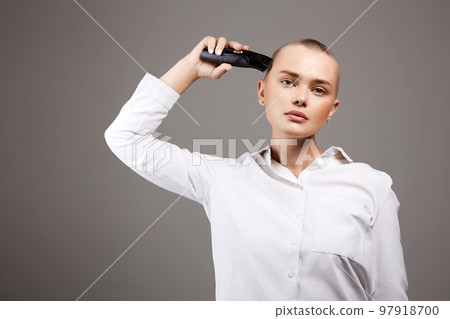 beauty portrait of bald Girl with hairclipper beauty portrait of bald Girl with hairclipper 97918700