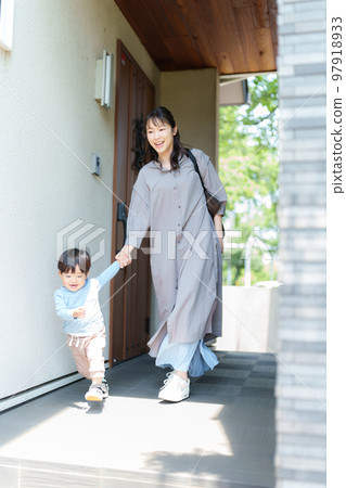2 year old boy pulling his mother's hand 97918933